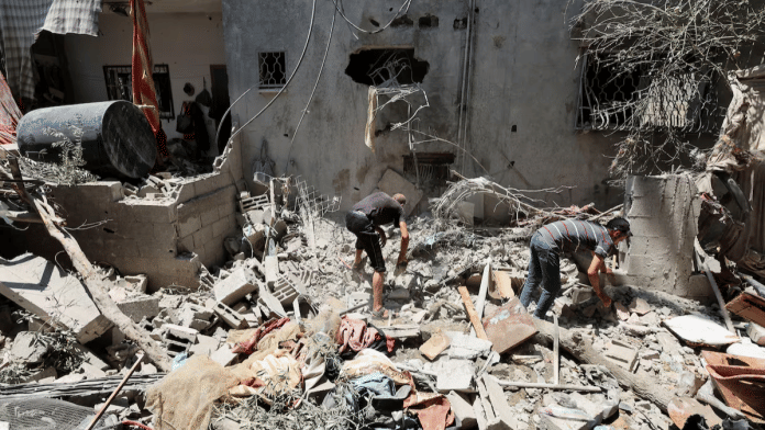 Palestinians inspect a house hit in an Israeli strike, amid the Israel-Hamas conflict, in Deir Al-Balah in the central Gaza Strip, July 15, 2024 | Reuters