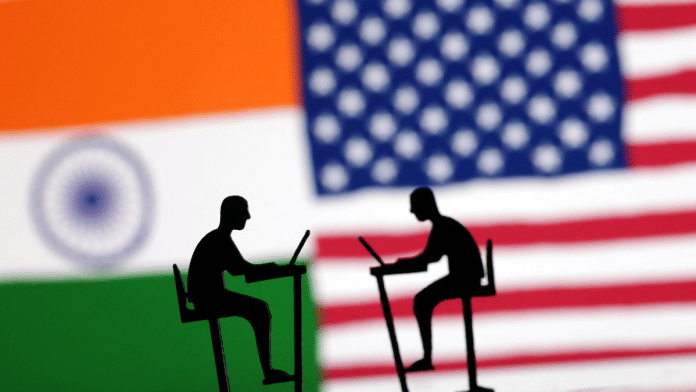 The Indian flag, the U.S. flag and people miniatures with laptops are seen in this illustration taken March 10, 2024 | File Photo | Reuters