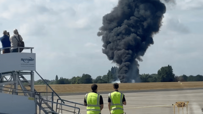 A plume of black smoke rises from an area near the runway after a small plane crash, as seen from inside a building at London Southend Airport, in Southend, Britain, July 13, 2025, in this screen grab obtained from a social media video | Reuters
