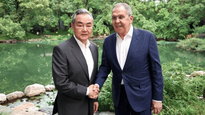 Chinese Foreign Minister Wang Yi shakes hands with Russian Foreign Minister Sergei Lavrov during a meeting on the sidelines of the SCO Foreign Ministers' Council meeting in Beijing, China July 13, 2025 | Reuters