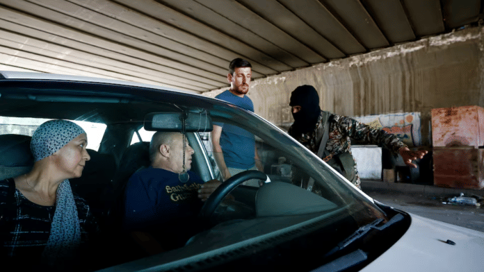 File photo of a member of the Syrian security forces gesturing next to a vehicle at the entrance of Druze town of Jaramana, following deadly clashes, in southeast of Damascus, Syria April 29, 2025 | Reuters