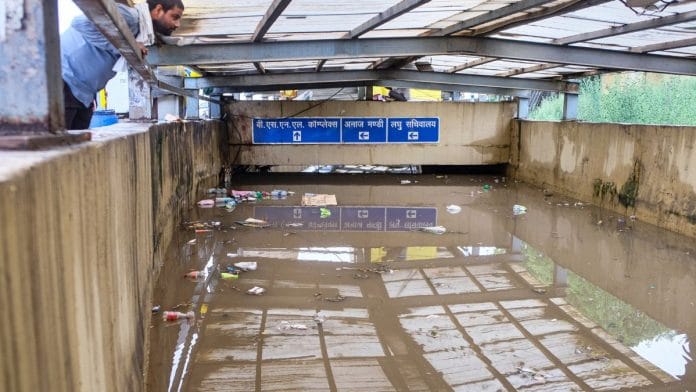 A man looks at a waterlogged subway at Rajiv Chowk after heavy rainfall in Gurugram | PTI