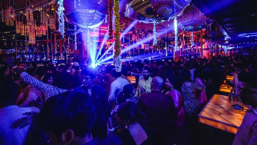 Colourful umbrellas, marigolds, and fairy lights complete the wedding illusion