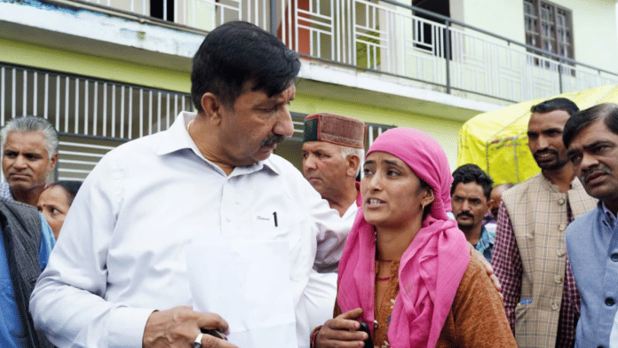 Himachal Pradesh Deputy Chief Minister Mukesh Agnihotri listens to a villager as he meets the cloudburst-affected people, in Mandi on 5 July 2025. | ANI