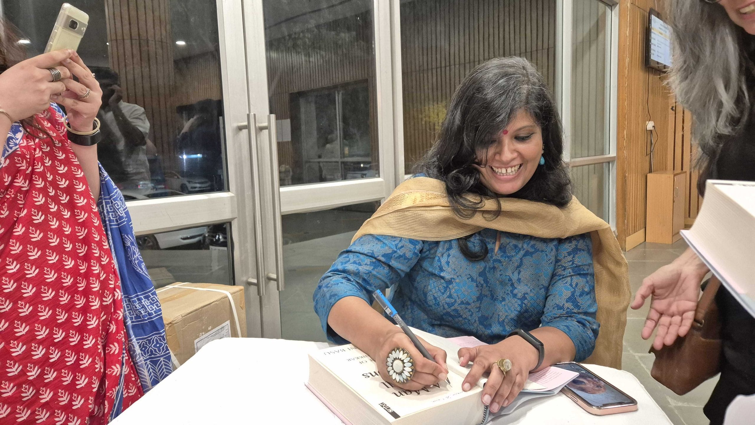 Historian Narayani Basu signing books for the audience members | Shubhangi Misra, ThePrint
