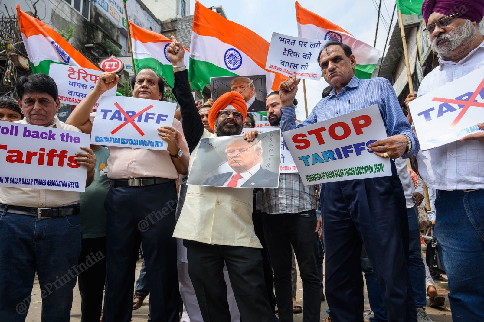 Members of Federation of Sadar Bazar Traders Association (FESTA) holding placards and raising slogans during a demonstration against tariffs imposed on Indian goods by the Trump administration, in New Delhi, on 30 August, 2025 | Ankit Roy