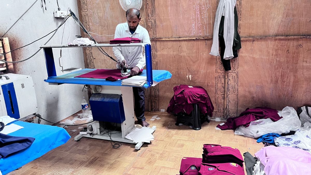 A worker ironing freshly stitched shirts at the ADR Shirts unit in the Chanpatia Startup Zone, Bihar | Fareeha Iftikhar | ThePrint