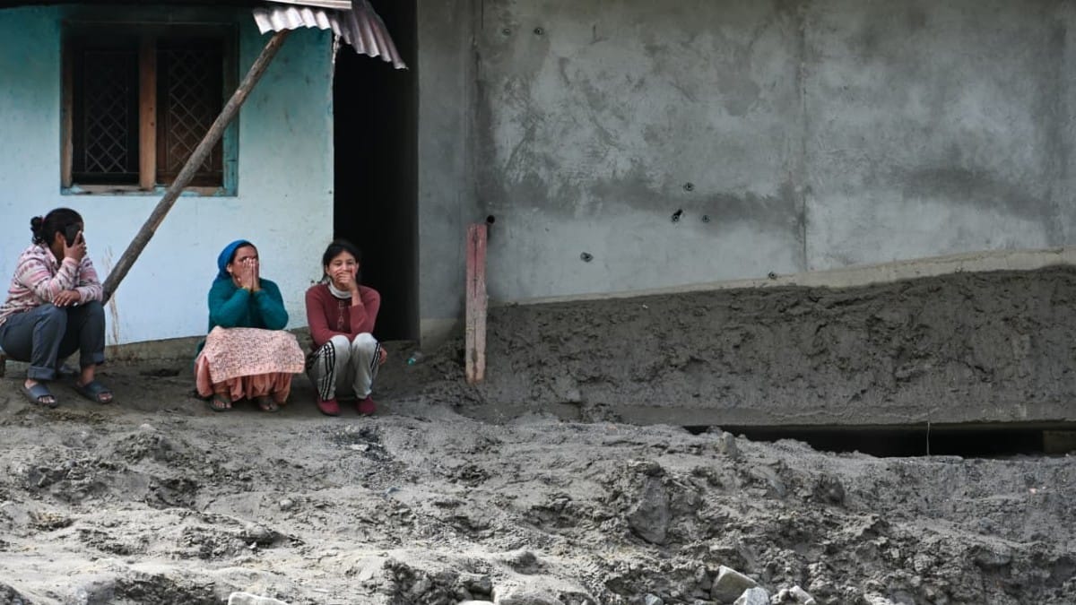Dharali residents sit on the porch of their house, surrounded by silt and debris | Suraj Singh Bisht | ThePrint