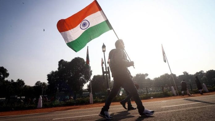 A man holds the flag of India in New Delhi | Photo: ANI