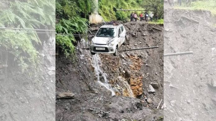 A car dangles on a damaged road in Himachal Pradesh | Photo: By special arrangement