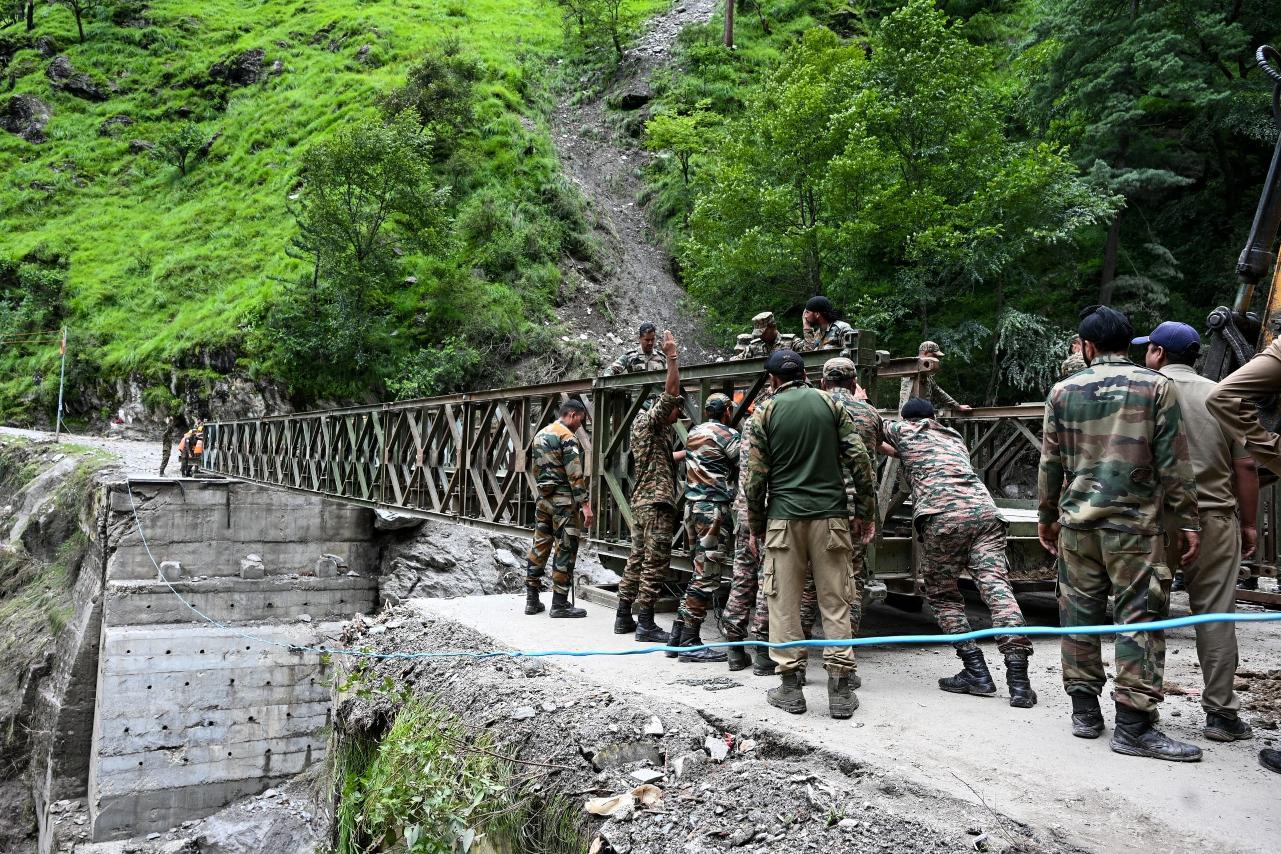 Army personnel and BRO workers working on the bridge which was totally damaged after the flash flood | Photo: Suraj Singh Bisht | ThePrint