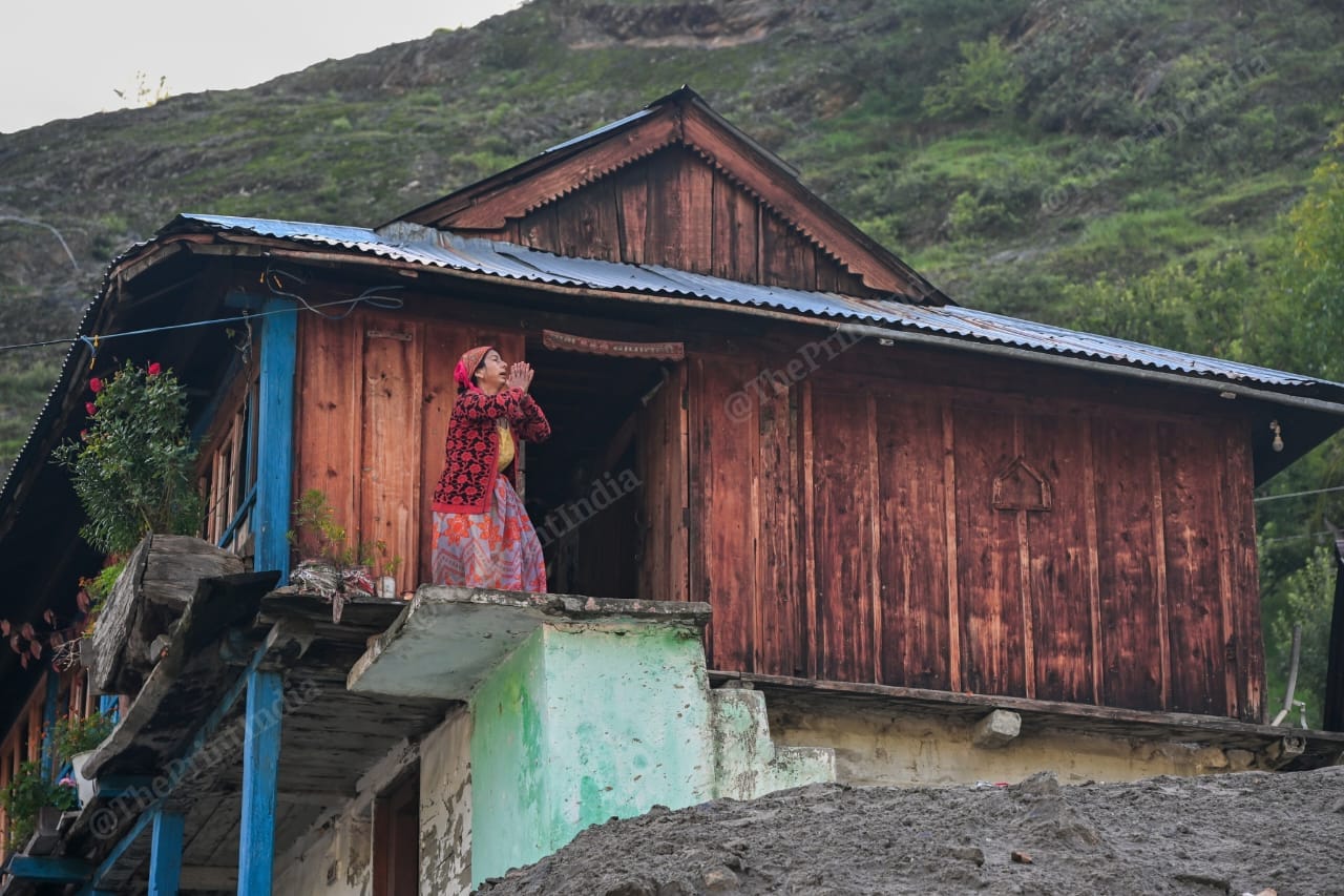 A woman prays with folded hands in Dharali, Uttarkashi | Suraj Singh Bisht | ThePrint