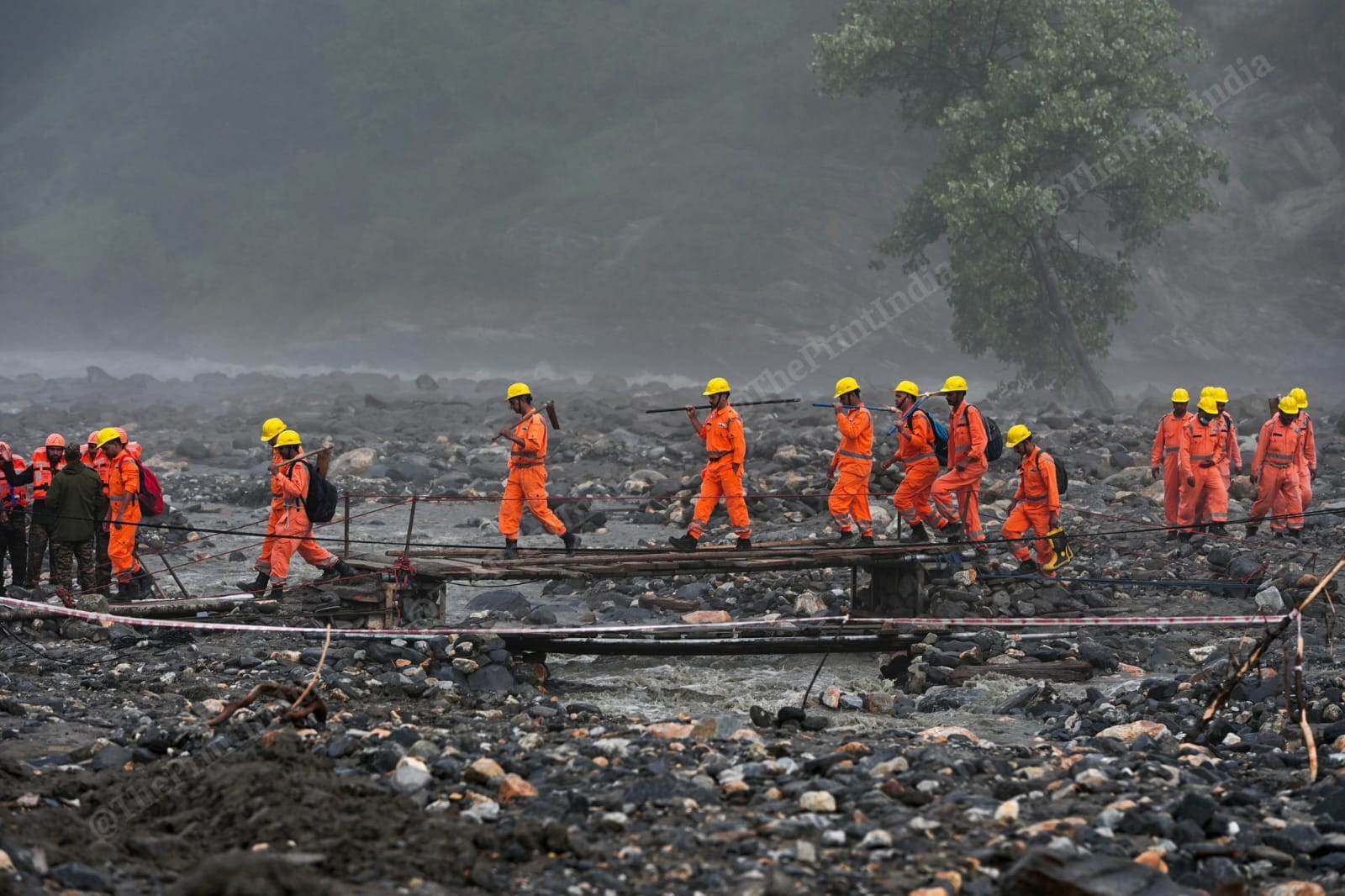NDRF personnel crossing a wooden bridge for rescue operations | Suraj Singh Bisht | ThePrint