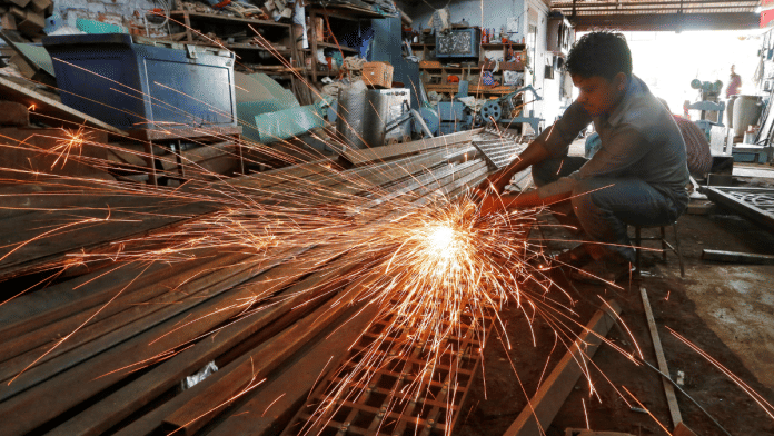 A worker grinds a metal gate inside a household furniture manufacturing factory in Ahmedabad, India | Representational image | Reuters