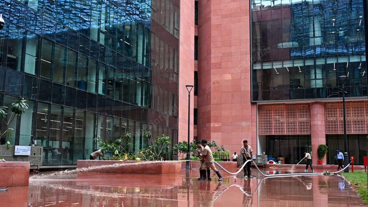 Workers hosing down a courtyard at the Kartavya Bhawan 3, part of the Common Central Secretariat (CCS) in New Delhi, ahead of its inauguration by PM Narendra Modi | Suraj Singh Bisht | ThePrint