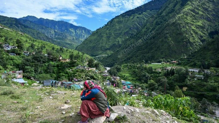 Kala Devi peers at the sky, waiting for the helicopter that could ferry her back to her family in Uttarakhand's Dharali village; she and her husband Peer Singh, both originally from Nepal, were among the few who survived the flash flood that struck Uttarkashi on 5 August, 2025 | Suraj Singh Bisht | ThePrint