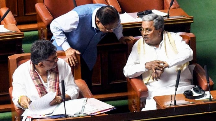 Karnataka CM Siddaramaiah in conversation with Dy CM DK Shivakumar and Home Minister G Parameshwara during Assembly monsoon session, in Bengaluru, on 19 August, 2025 | ANI