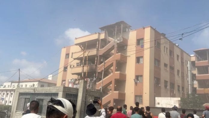 People walk at the site of Israeli strikes on Nasser hospital where Palestinian cameraman Hussam al-Masri, who was a contractor for Reuters, was killed along with other journalists and people, in Khan Younis in the southern Gaza Strip in this still image taken from video, August 25, 2025. | REUTERS