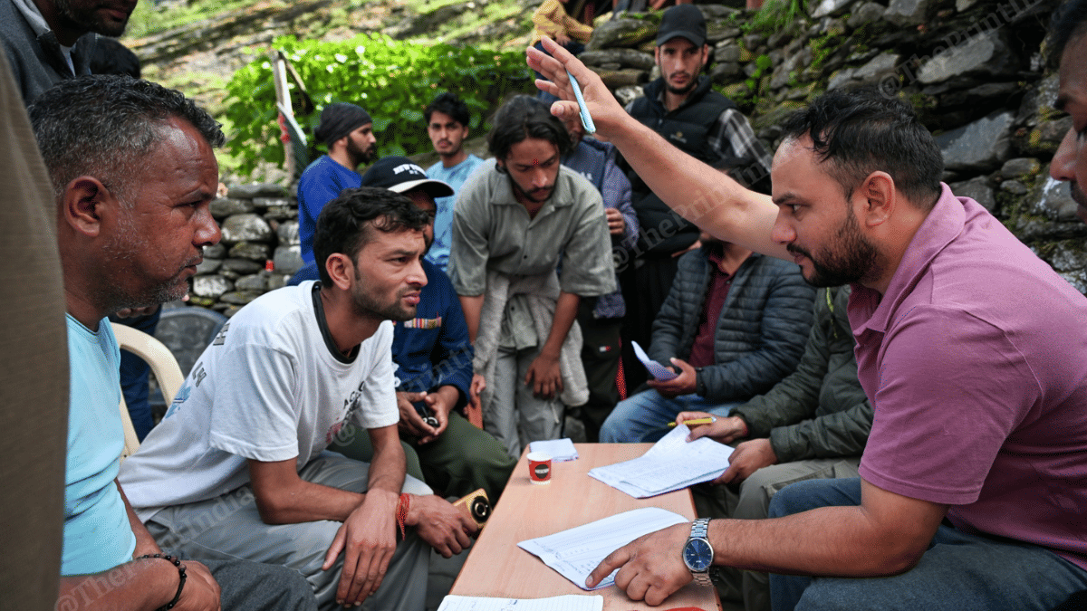 A staff of horticulture department takes down details of people who lost crops, fruits and vegetables to the floods | Suraj Singh Bisht | ThePrint
