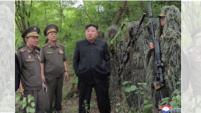 North Korean leader Kim Jong Un stands next to snipers during a visit to a special operation training base at an undisclosed location in this undated picture released by North Korea's official Korean Central News Agency | Reuters
