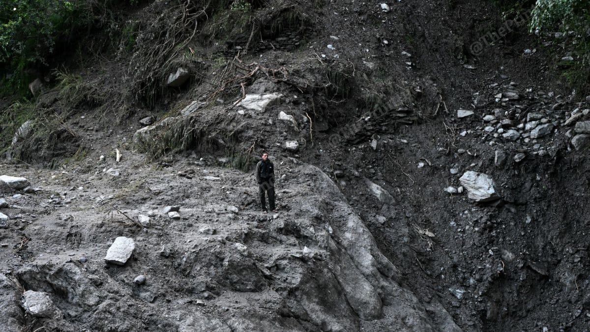 A construction worker looks at the trail of destruction left behind by the flash flood that struck parts of Uttarkashi on 5 August, washing away an entire village, besides arterial roads that lead to it; Army, ITBP, NDRF and SDRF along with local authorities are working round-the-clock to restore connectivity and utilities in affected parts | Suraj Singh Bisht