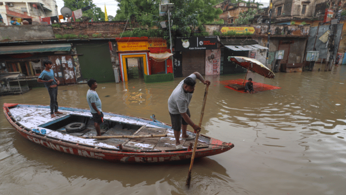 People use a boat to commute in a flooded locality as the swollen Ganga river inundates nearby areas, in Varanasi, Uttar Pradesh, Monday, 4 August 2025. | PTI