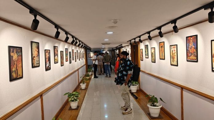 Visitors taking a look at the poster exhibition held at NCUI Delhi | Tina Das, ThePrint