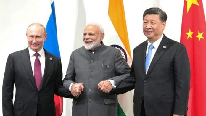 File photo of Russian President Vladimir Putin, Indian Prime Minister Narendra Modi and Chinese President Xi Jinping on the sidelines of the G20 summit in Osaka on 28 June 2019 | Photo: Mikhail Klimentyev | AFP/Getty Images via Bloomberg