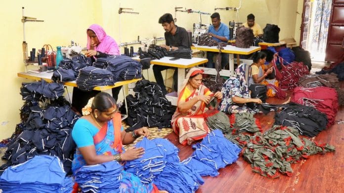 Workers in a small-scale garments unit near Velampalayam, Tiruppur