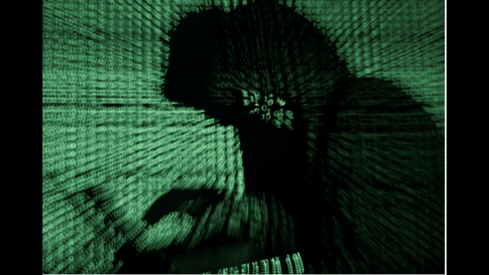 A man holds a laptop computer as cyber code is projected on him in this illustration picture taken on May 13, 2017. | Reuters