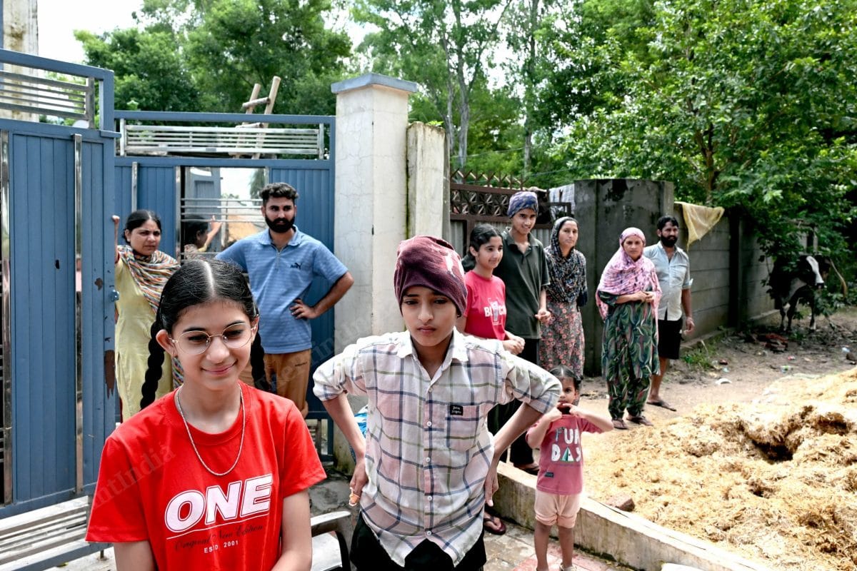 Local villagers standing outside their houses waiting for daily essentials which are being distributed in tractors | Suraj Singh Bisht | ThePrint