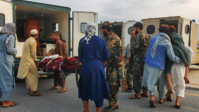 Taliban soldiers and civilians carry earthquake victims to an ambulance at an airport in Jalalabad, Afghanistan, 1 September 2025. | Stringer | Reuters
