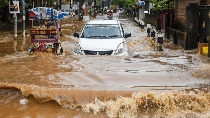 Vehicles wade through a waterlogged road after heavy rainfall, in Guwahati, Assam, Tuesday, 16 Sept, 2025 | PTI