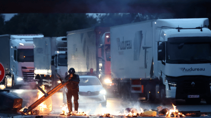 A police officer removes an object placed by demonstrators to block traffic on the ring road, as part of a grassroots protest movement called 'Bloquons Tout' (Let's Block Everything) calling for nationwide all-day disruption, in Nantes, France, 10 September 2025. | Stephane Mahe | Reuters