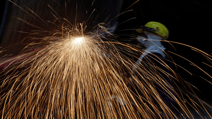A worker cuts a metal plate inside a industrial tank manufacturing factory on the outskirts of Ahmedabad, India, January 31, 2025 | Representational image | Reuters