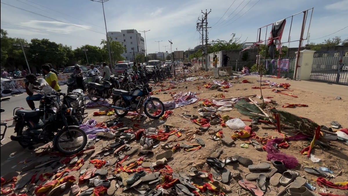 Discarded slippers, besides torn banners and flags of Vijay’s TVK scattered around Velusamypuram in Karur | ThePrint/Prabhakar Tamilarasu