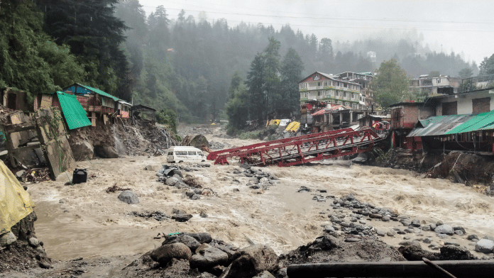 A tempo traveller stuck in the middle of the Manalsu drain due to continuous heavy rains, in Kullu on 2 September 2025. | ANI