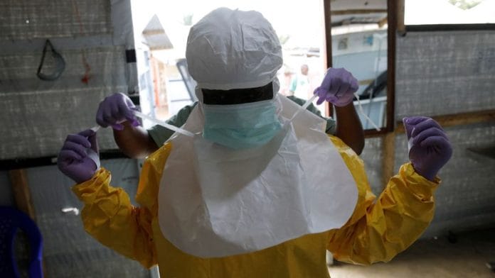 A health worker puts on Ebola protection gear before entering the Biosecure Emergency Care Unit (CUBE) at the ALIMA (Alliance for International Medical Action) Ebola treatment centre in Beni, in the Democratic Republic of Congo, on 31 March 2019. | File Photo | Baz Ratner | Reuters