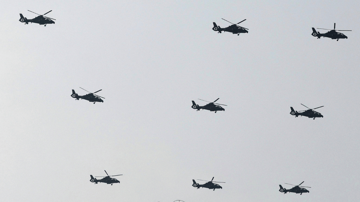 Helicopters fly past during military parade to commemorate the 80th anniversary of the end of World War II. AP/PTI