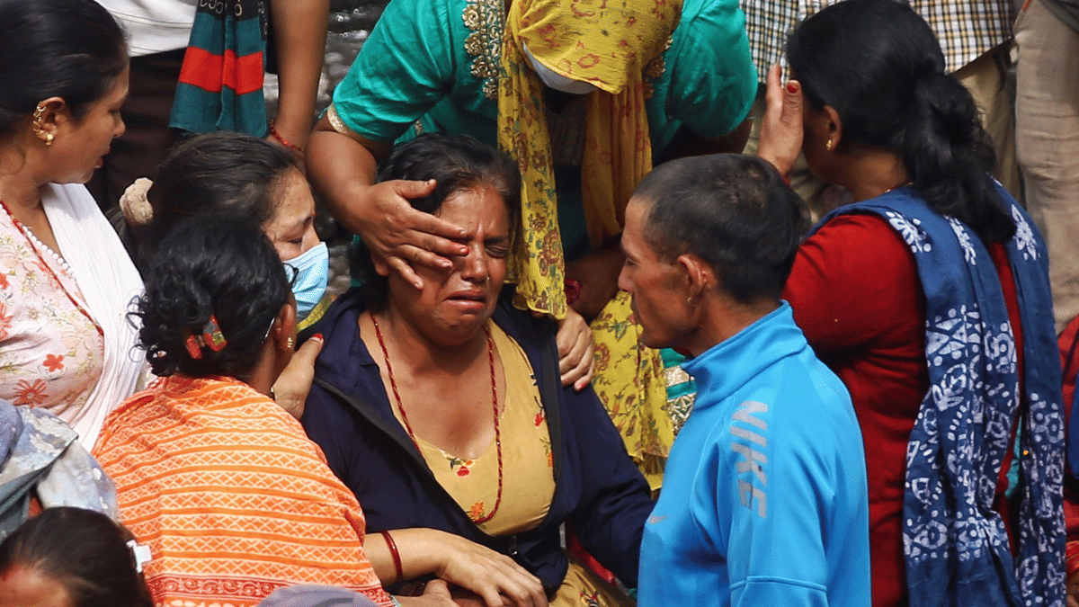 Budhathok Mahen’s inconsolable mother at the steps of the Pashupatinath temple. | Manisha Mondal/ThePrint