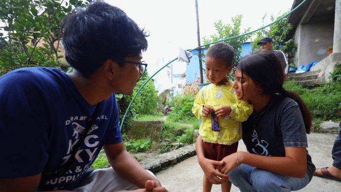Shridh Raj Khanaya and Samyah Devkota with a child who lost father in the protest | Manisha Mondal | ThePrint