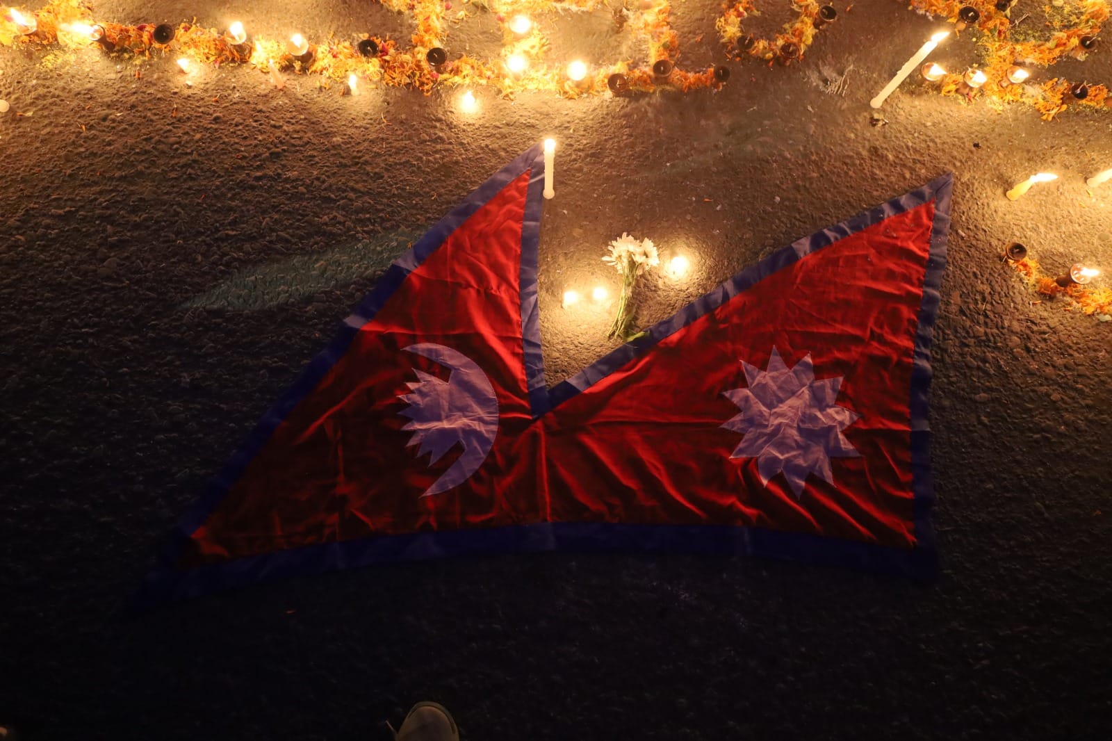 A white flower is kept next to the national flag of Nepal | Manisha Mondal | ThePrint