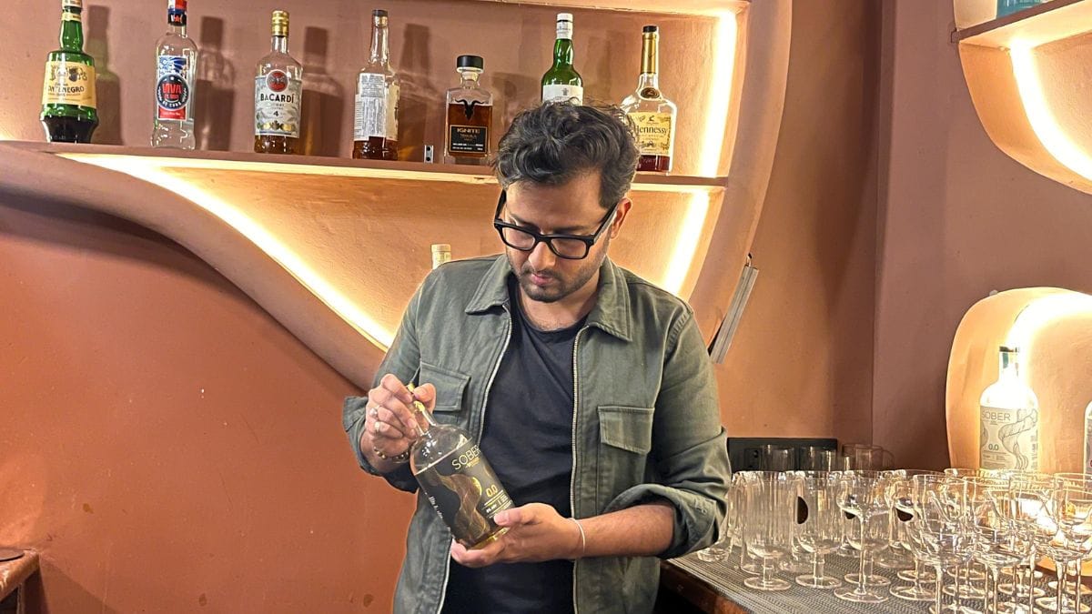 Vansh Pahuja, founder of non-alcoholic drink brand Sober, poses with Sober Rum | Saqiba Khan
