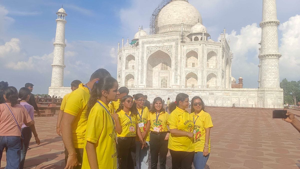 The group poses in front of the Taj Mahal for both group and individual photos | Almina Khatoon, ThePrint