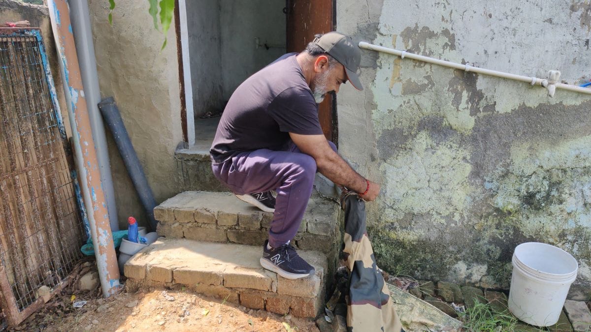 Anil Gandas, trying to catch a monitor lizard at a house in Mohammadpur village, Gurugram | Sakshi Mehra, ThePrint