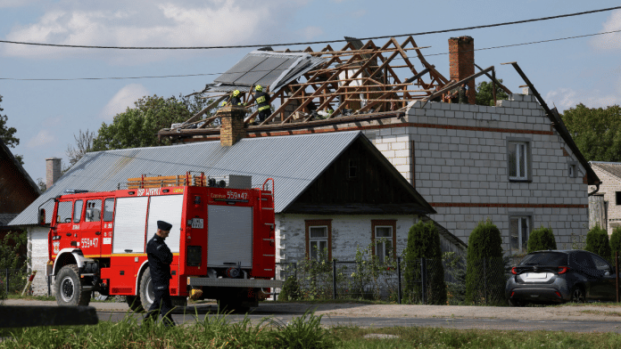 A police officer stands below as firefighters work on the destroyed roof of a house, after Russian drones violated Polish airspace during an attack on Ukraine, with some being shot down by Poland with the backing from its NATO allies, in Wyryki, Lublin Voivodeship, Poland, September 10, 2025 | Reuters file phto