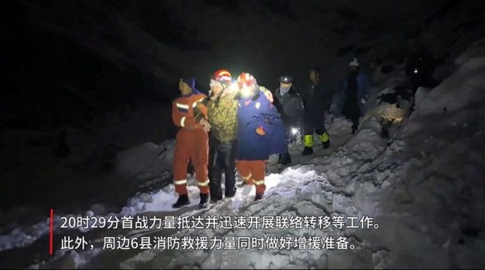 Tibetan firefighters rescue trekkers from Everest after they were stranded by a blizzard, in Tingri in this screen grab taken from a video released on 6 October 2025. | Tibet Firefighting Department | Handout via Reuters