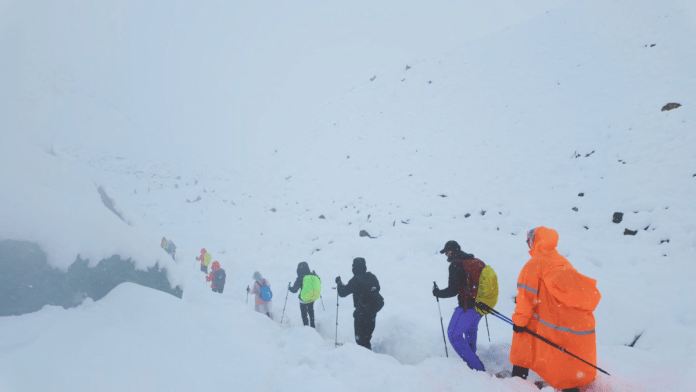 A screen capture from video shows trekkers leaving their campsite, as unusually heavy snow and rainfall pummeled the Himalayas, in the Tibet Region on 5 October 2025. | Geshuang Chen | Handout via Reuters