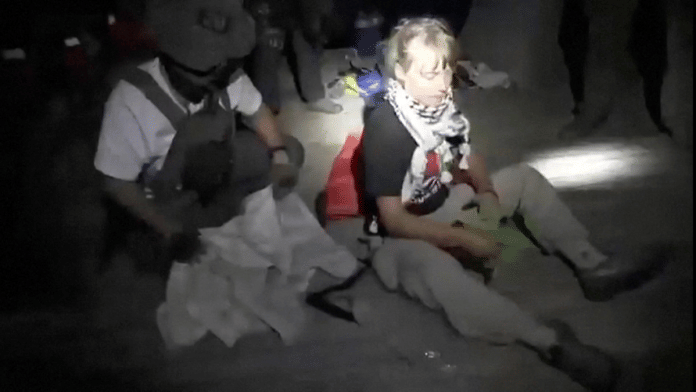 A screengrab from a video shows Swedish activist Greta Thunberg sitting next to a person wearing tactical gear, as vessels of the Global Sumud Flotilla are being intercepted by Israeli security forces, on 1 October 2025. | Israel Foreign Ministry | Handout via Reuters