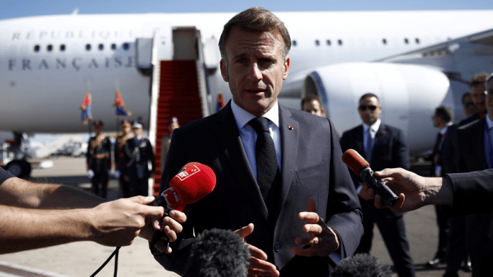 French President Emmanuel Macron speaks to the members of the media, after arriving by plane to attend the Gaza Peace Summit, in Sharm el-Sheikh on 13 October 2025. | Yoan Valat | Pool via Reuters